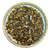 Herbal tea mix on a decorative plate with a white background