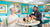 The founders enjoying afternoon tea in a stylish cafe with blue walls and decorative elements.